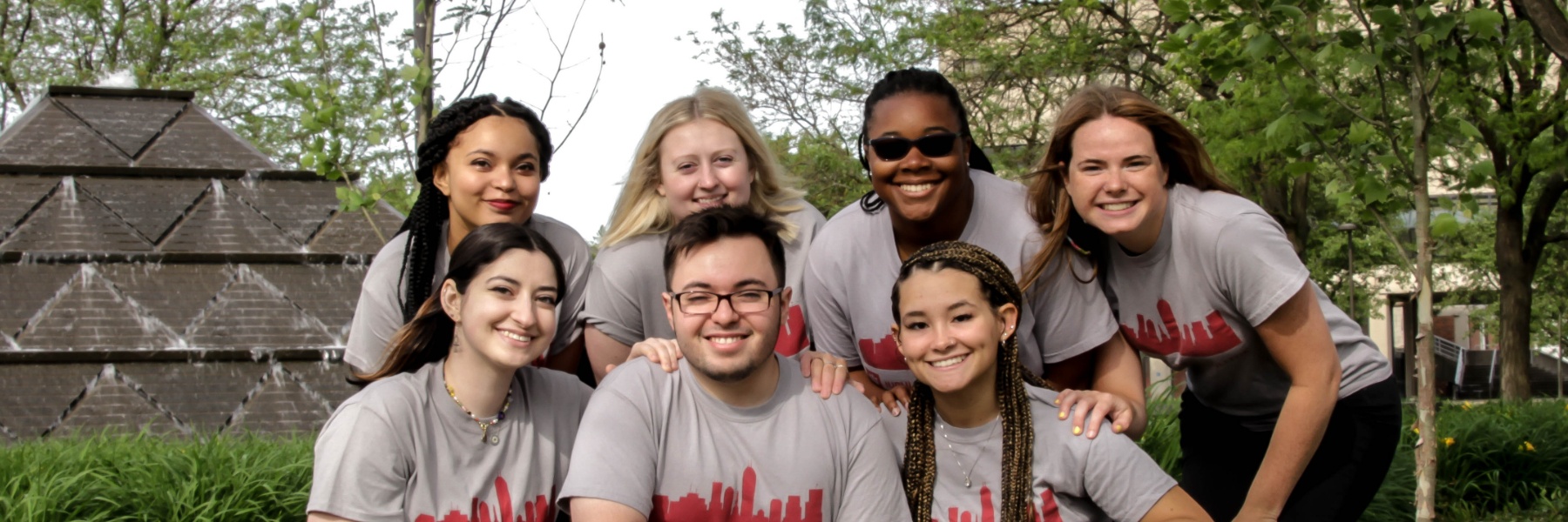Image of seven Peer Advisors in front of the Pyramid fountain on the IUPUI campus.